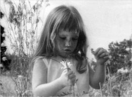 The young girl pulling petals off a flower depicted in Lyndon B. Johnson's 1964 "Peace Little Girl (Daisy)" Presidential Campaign ad. (Credit: NBC Universal)