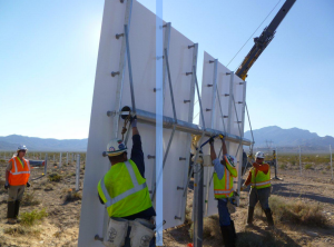 Construction workers secure a heliostat onto a pylon. (Credit: BrightSource Energy)